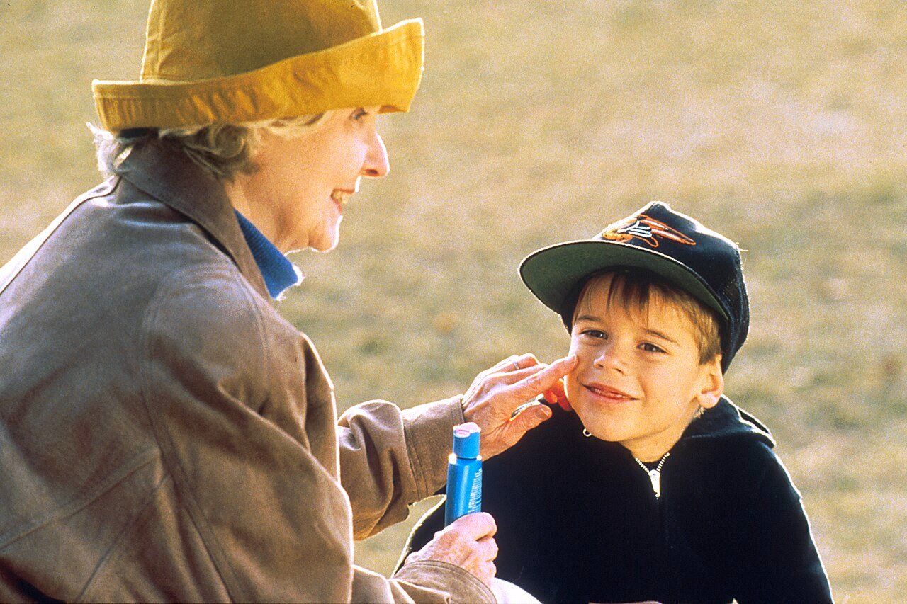 A child having sunscreen applied