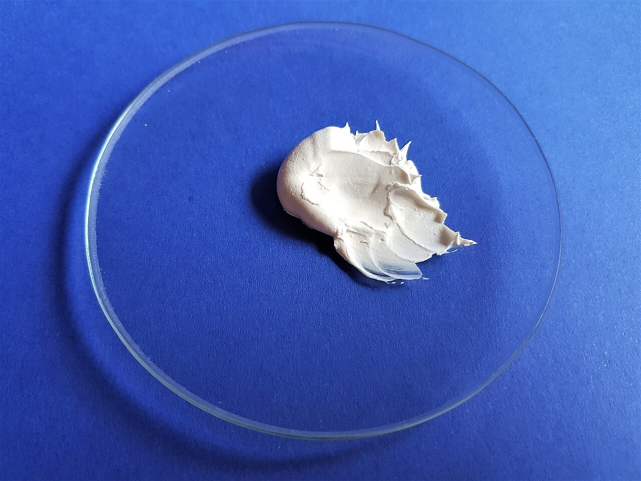 A jar of white zinc oxide cream