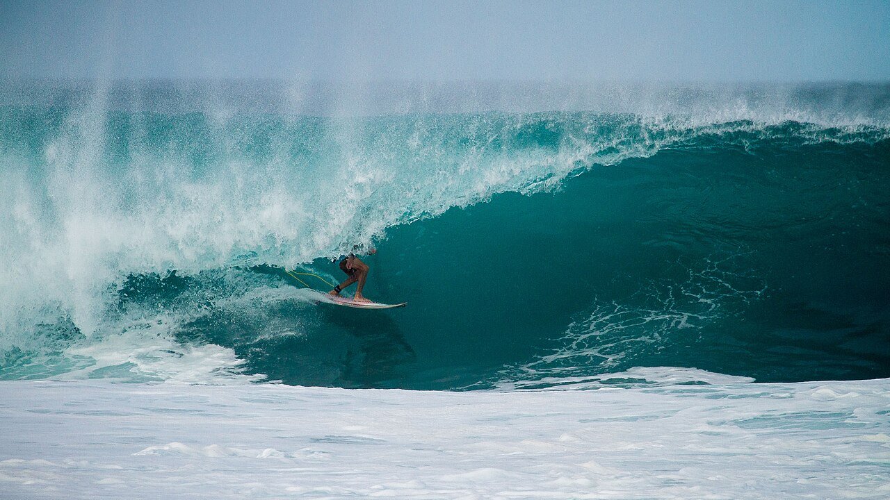 A surfer riding a wave in the open ocean